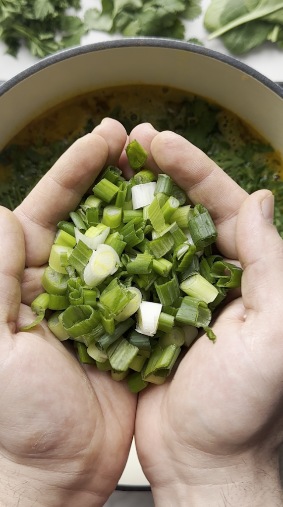 diced green onions going into the aush/ash pot